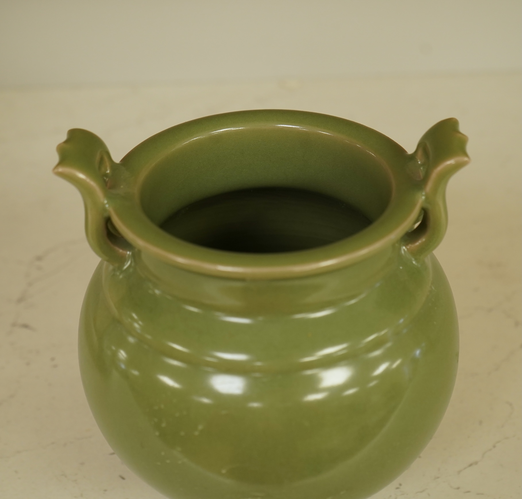 A Chinese green glazed censor on tripod feet, 16cm high